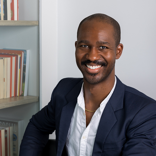 David Osborne smiling in a navy blazer and white shirt